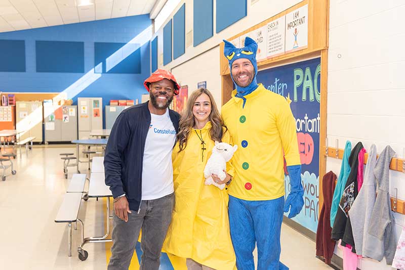 Constellation team at school literacy event with Pete the Cat promoting reading programs