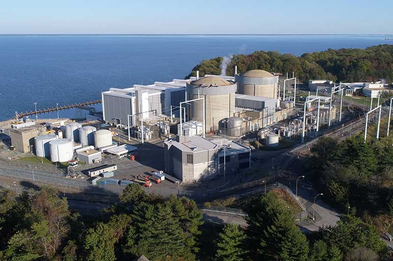 Aerial view of Constellation Calvert Cliffs Clean Energy Center near water with cooling towers and infrastructure