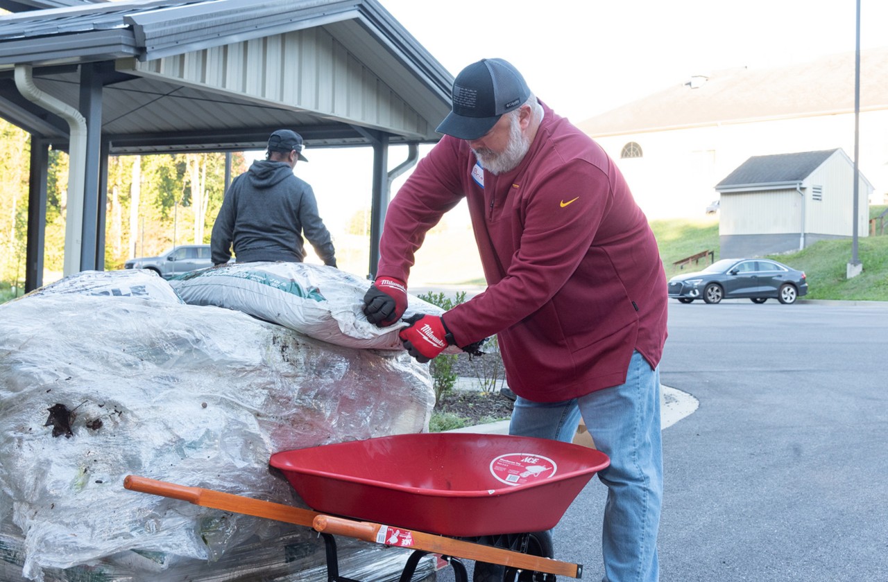 Volunteer prepares landscaping materials during a community service project