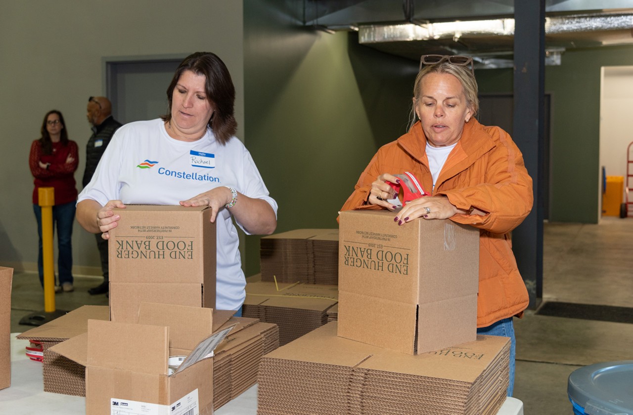 Volunteers assemble End Hunger Food Bank boxes during a community service project