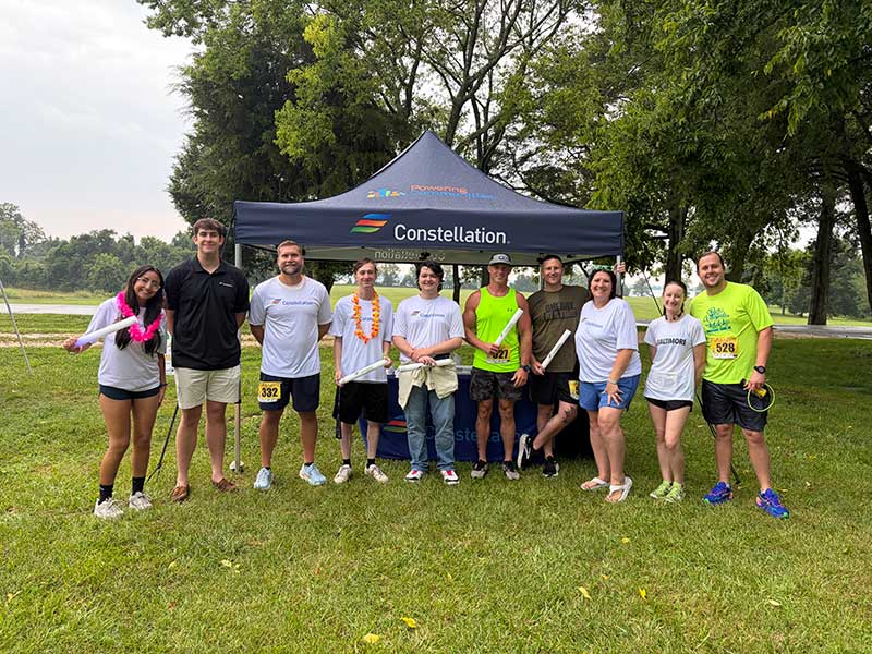 5K run group shot under Constellation tent