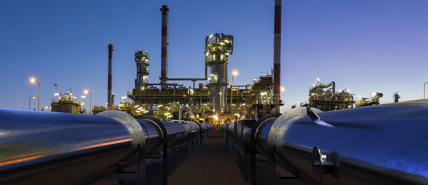 Pipes of oil leading to plant at night