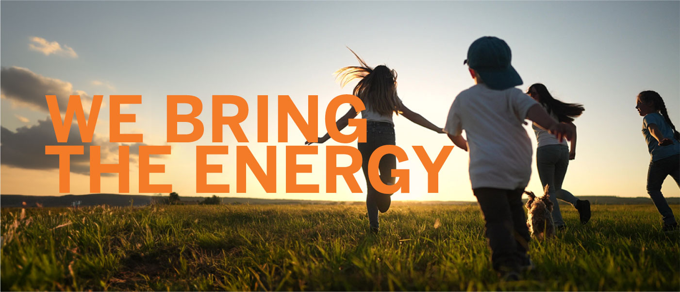 kids running in a field with a sunset and the words we bring the energy overlayed