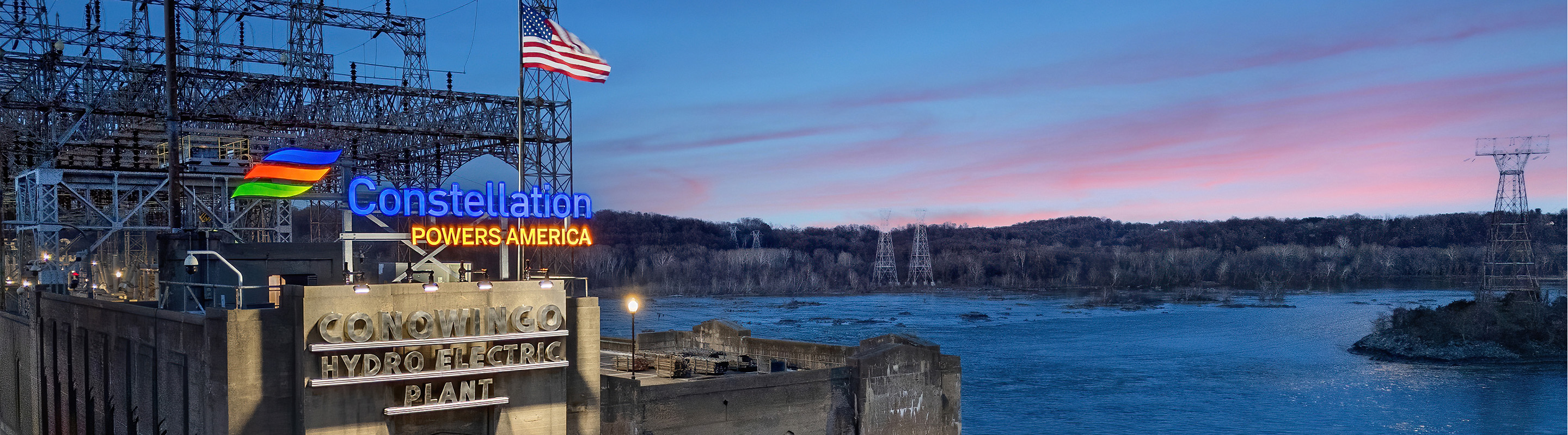 Constellation Powers Amercia sign lit up with sunset at Conowingo Hydroelectric Plant