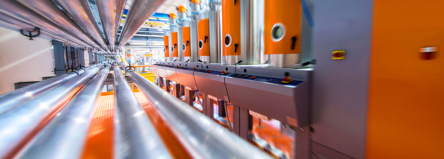 Steel pipes and machiines in a factory