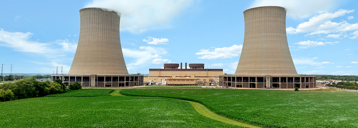 Bryron cooling towers on a sunny day behind green grass