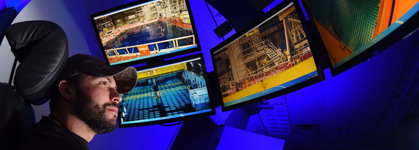 Man working whole looking at multiple computer screens