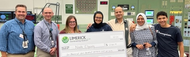 Student receiving check at nuclear power plant