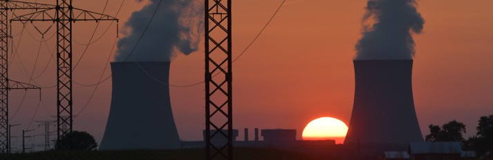 Cooling towers at sunset. Transmission lines in foreground.