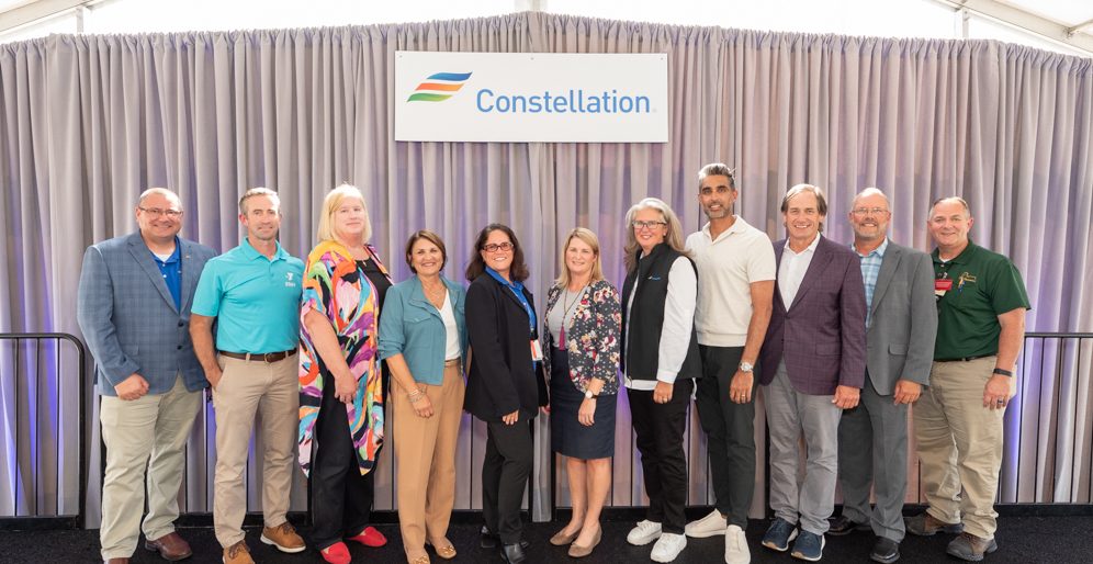 Constellation, Meta and local Illinois reps posing on stage at Clinton Clean Energy Center Celebration