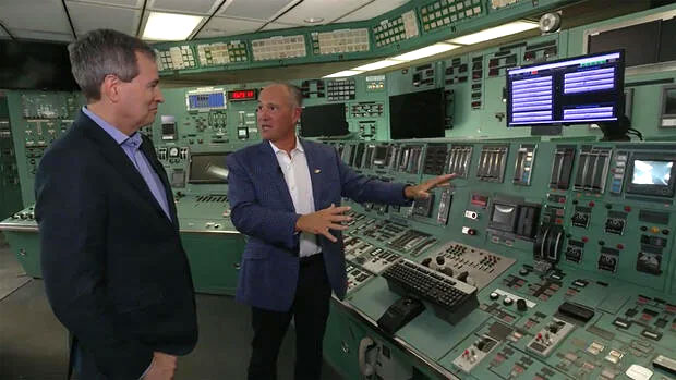 Correspondent David Pogue with Joe Dominguez, CEO of Constellation Energy, in the control room at the Crane Clean Energy Center