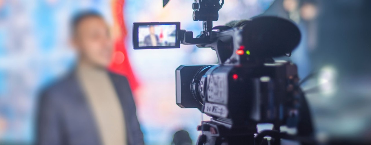 cameraman filming an interview