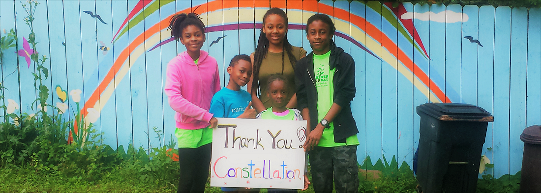 Program participants holding a "Thank You Constellation" sign. 